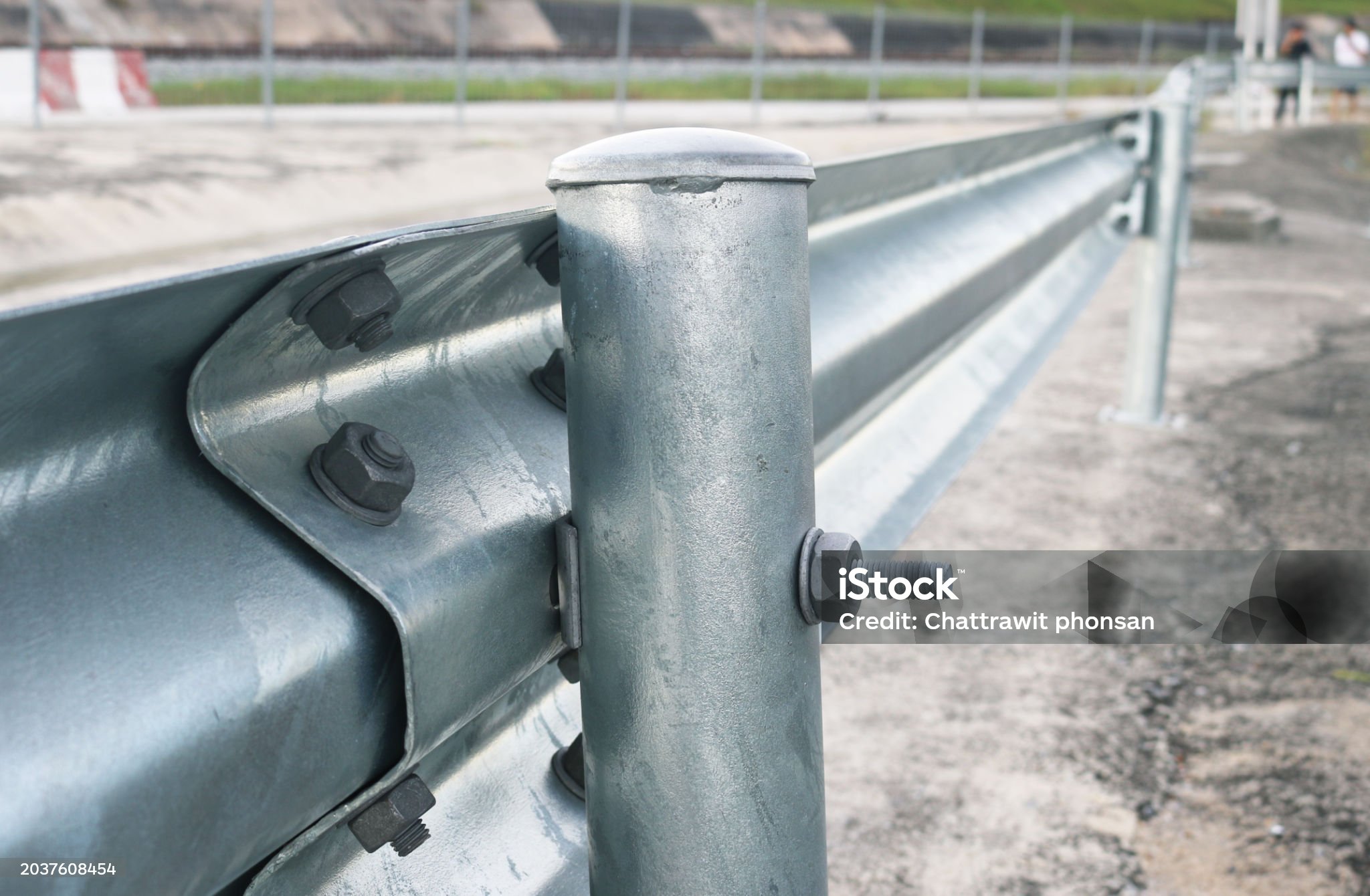Close-up galvanized steel w-beam guardrail.